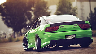 green sports coupe on road near trees at daytime HD wallpaper