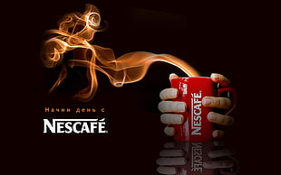 person holding red Nescafe ceramic cup