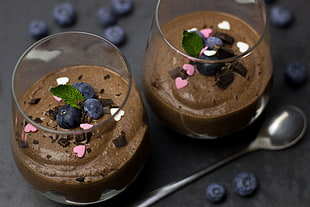 two chocolate mousse in clear glasses