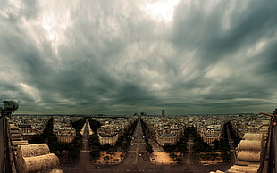 photography of buildings under gray clouds
