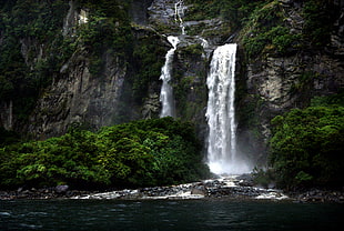 waterfalls in brown cliff
