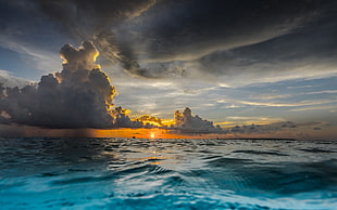 blue body of water above gray and black cloud