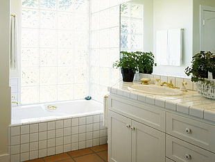 white ceramic sink and bathtub