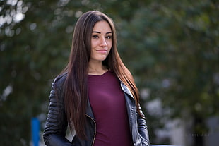 woman wearing purple shirt and black zip-up leather jacket