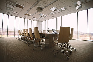 brown chairs lined-up near conference table