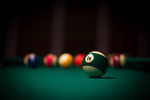 selective focus photography of Number 14 billiard ball on billiard table