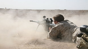 soldier holding black snipe gun