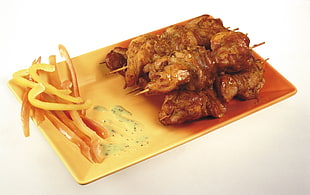 brown cook dish on brass rectangular plate