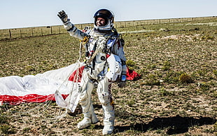 man in white paragliding suit