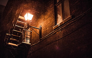 black metal framed glass top table, night, snow, lantern, wall