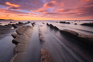 top view of stone and body of water under sunset
