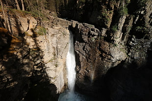 flowing water falls on rocky mountain HD wallpaper