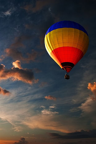 red and yellow hot air balloon during daytime