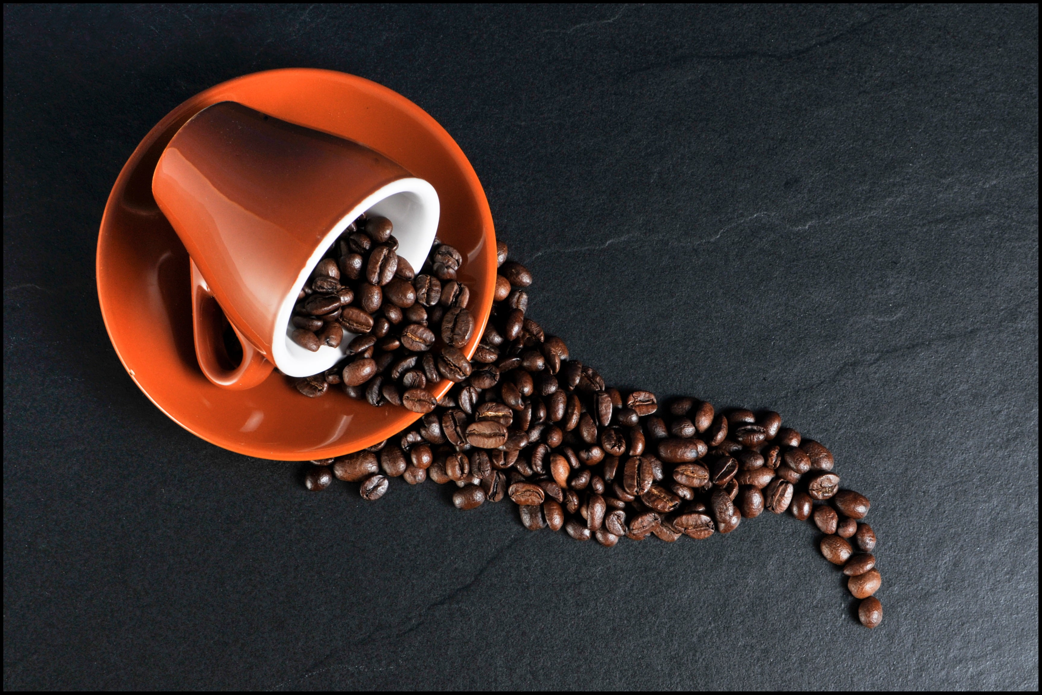 spilled coffee beans on mug