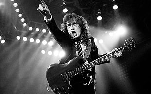 man playing guitar in stage, AC/DC, Angus Young