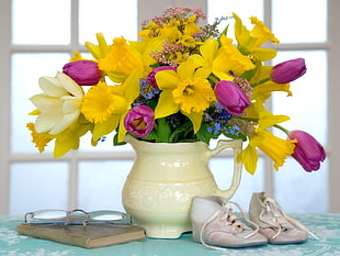 yellow Daffodils and pink Tulips with white flower vase