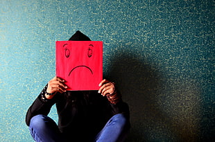 person with red sad paper mask HD wallpaper