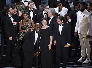 photo of people holding Oscars award trophy