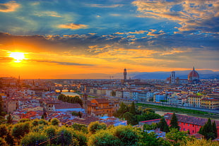 aerial view of high buildings and green trees with sunrise during day time, florence