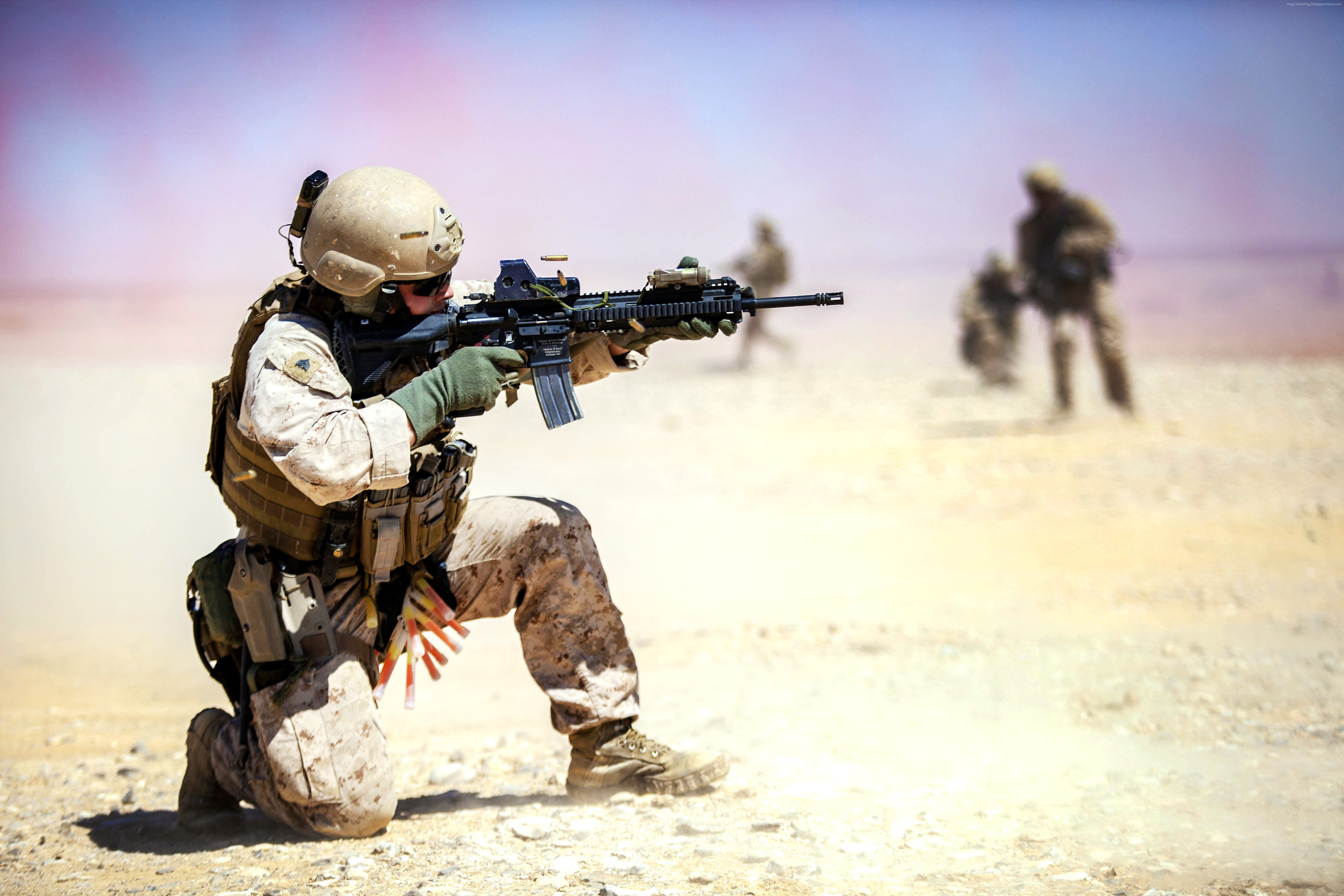 Soldier holding black assault rifle crouching