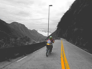 black and yellow fishing rod, motorcycle, highway, adventurers, selective coloring