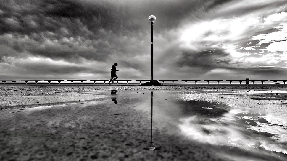 gray scale photo of person jogging near to body of water HD wallpaper