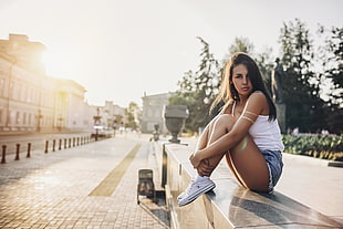 woman sitting on pavement during daytime HD wallpaper