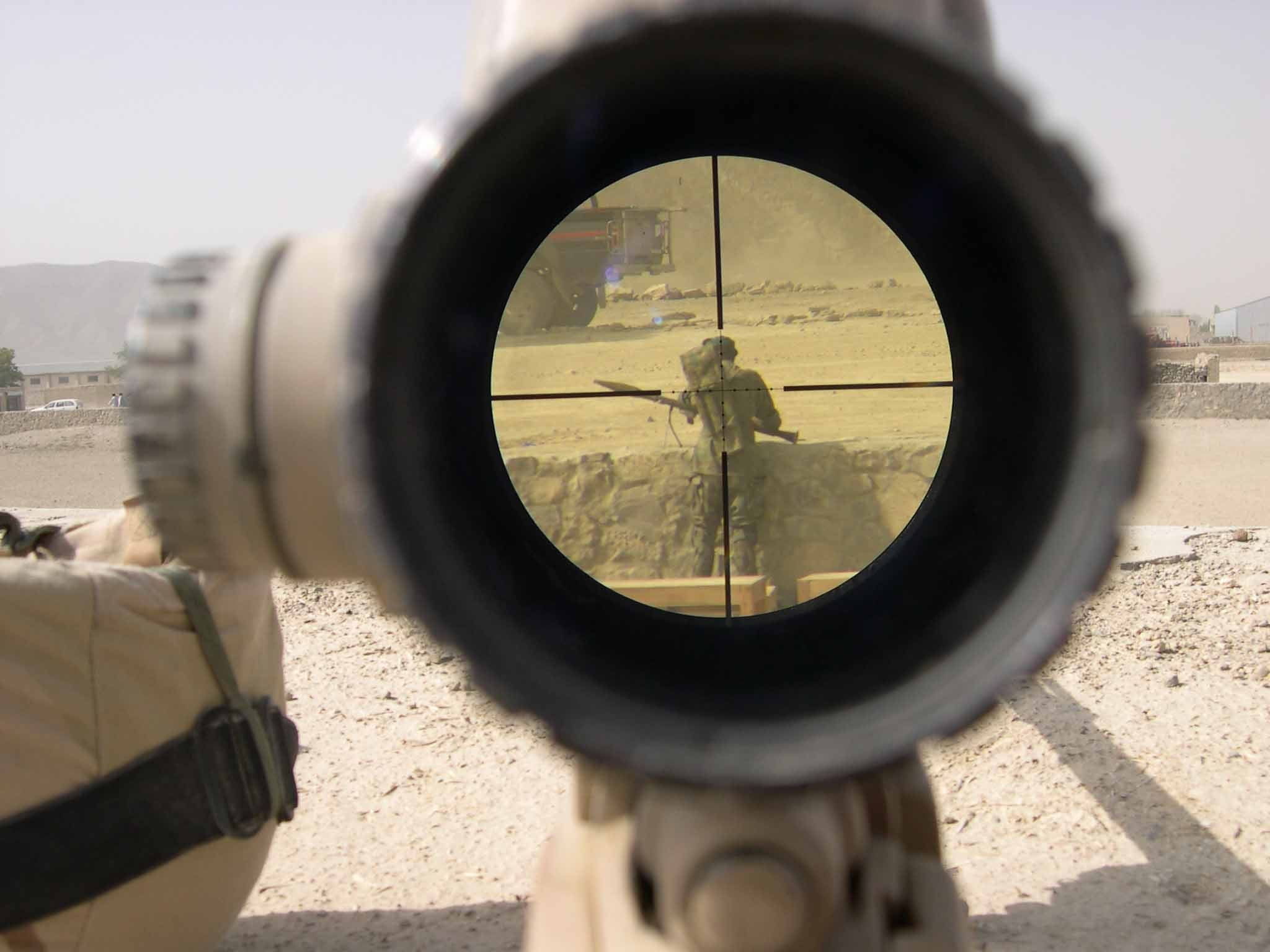 man carrying RPG view from rifle scope