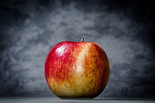 red apple on gray surface