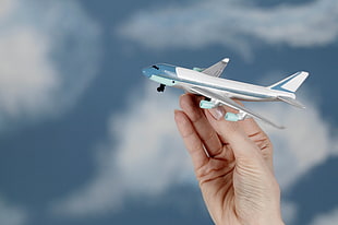 person holding plane scale model