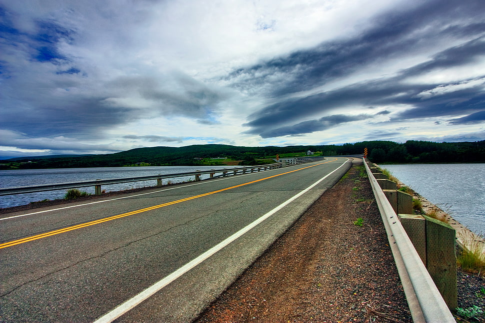 concrete road near sea during daytime HD wallpaper