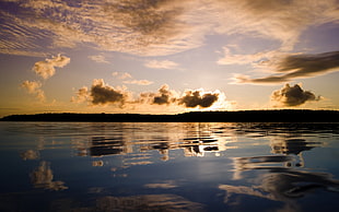 body of water and clouds during golden hour HD wallpaper
