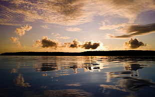 body of water and clouds during golden hour