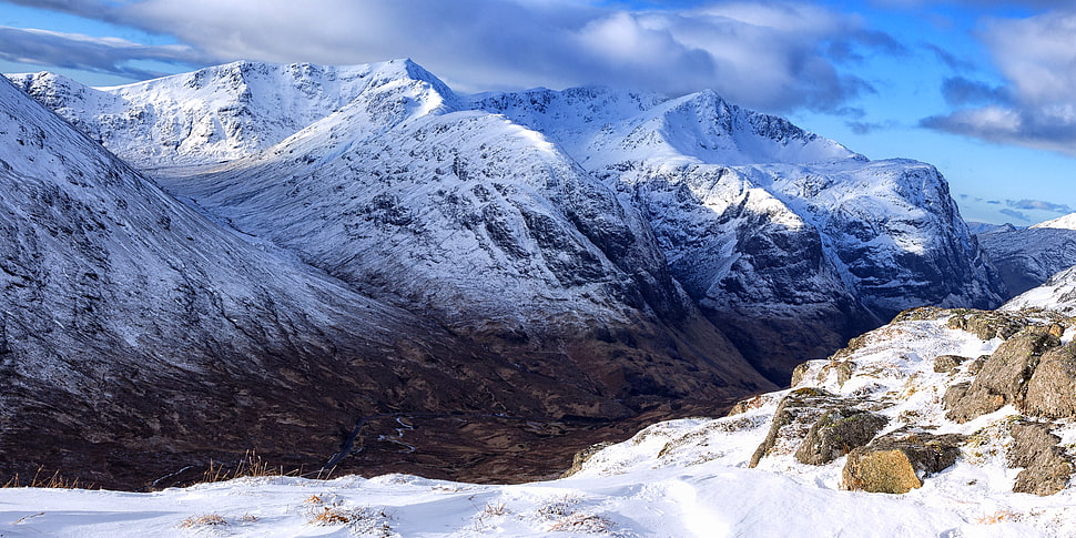 mountain covered with snow under cloudy sky HD wallpaper