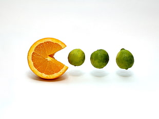 sliced lemon as Pacman and three green lemons
