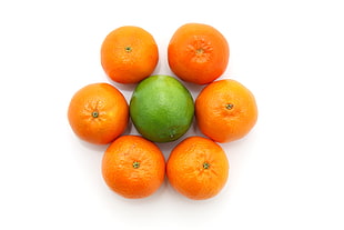 pile of six oranges and a guava