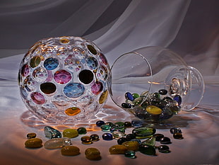 clear glass goblet and pebbles