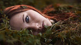 shallow focus photography of woman lying on ground