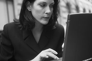 gray scale photo of woman wearing black blazer