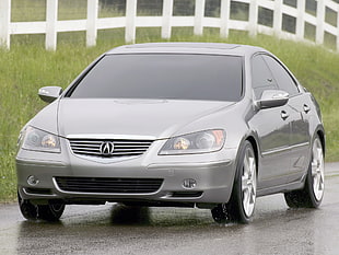 gray Acura sedan on wet road