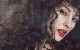 woman in red lipstick with curly black hair