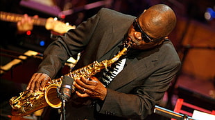 man in black suit playing saxophone HD wallpaper