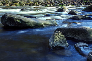 river with mineral rocks at daytime
