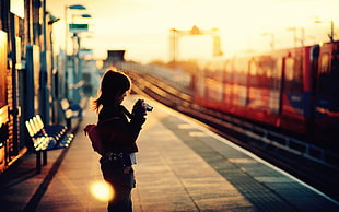 woman standing beside train HD wallpaper
