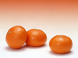 three orange fruits