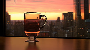 clear tea glass, tea, cityscape, sunset