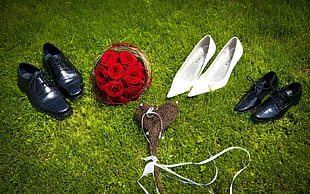 assorted pair of shoes with red rose bouquet