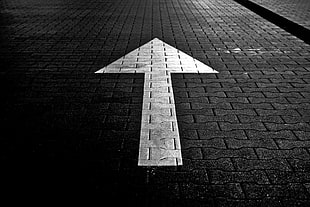 White Arrow Direction on Black Pavemet