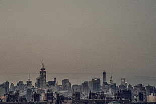 city skyline under cloudy sky HD wallpaper