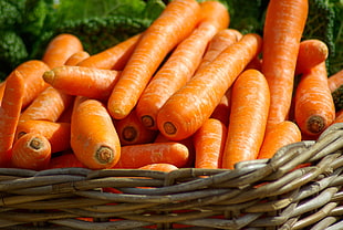 orange carrots in round woven brown wooden basket